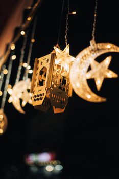 Close-up of illuminated lanterns and moon decorations, perfect for Eid celebrations.