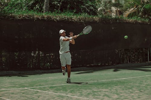 Man Playing Tennis on the Court Outdoors