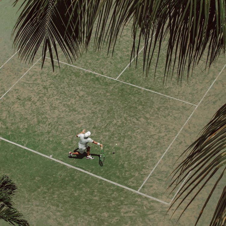 Man Playing Tennis On Grass Court