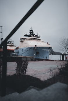 Cargo ship moored in a harbor at St. John's, Newfoundland on a cloudy day.