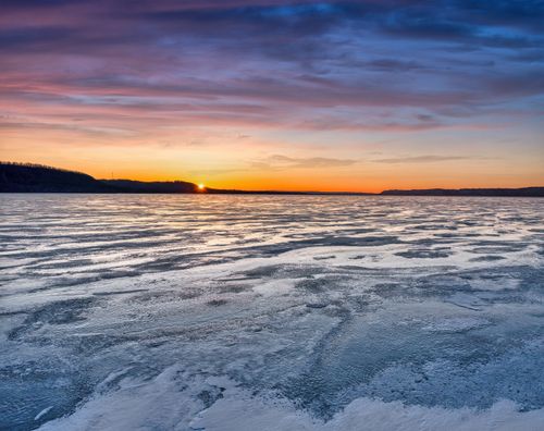 Free Stunning winter sunset over a frozen lake in Lake City, MN, USA showcasing vibrant skies and icy landscape. Stock Photo