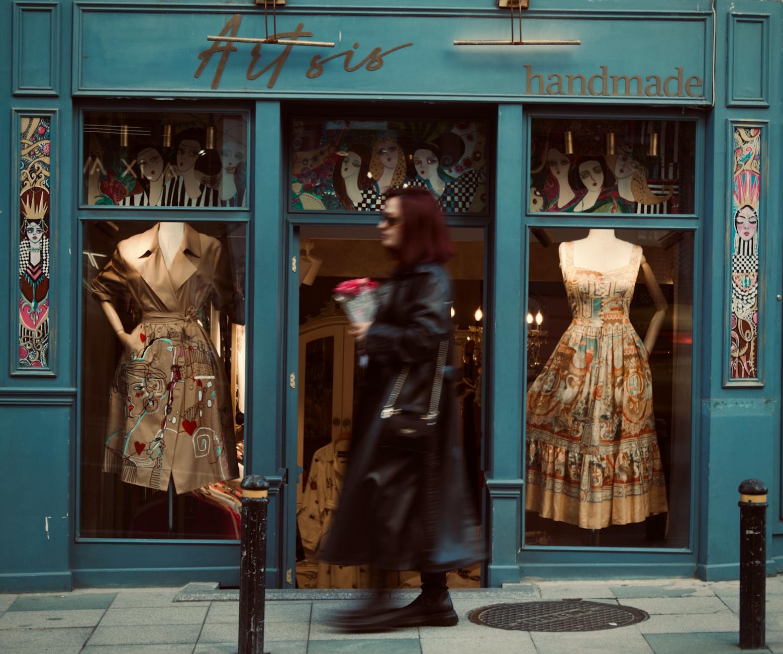 Chic boutique facade with artistic window display and fashionable handmade dresses.