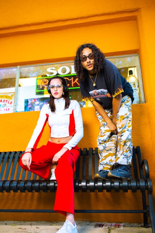 Free Stylish young adults in vibrant clothing posing in urban setting. Stock Photo