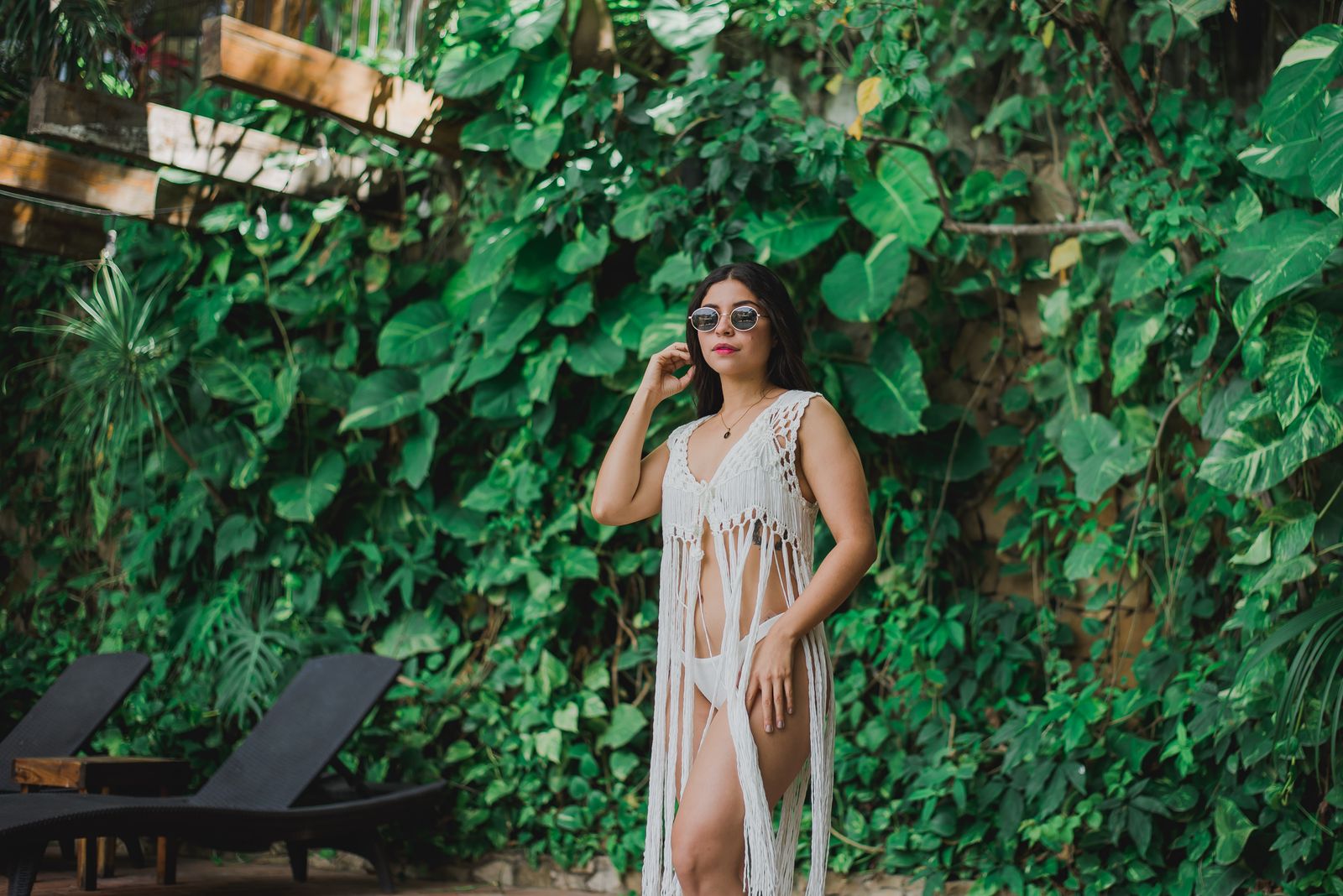 Woman enjoying comfortable tropical resortwear beside a luxury pool