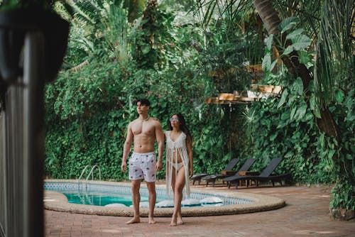 Young Couple by the Pool at the Tropical Resort 