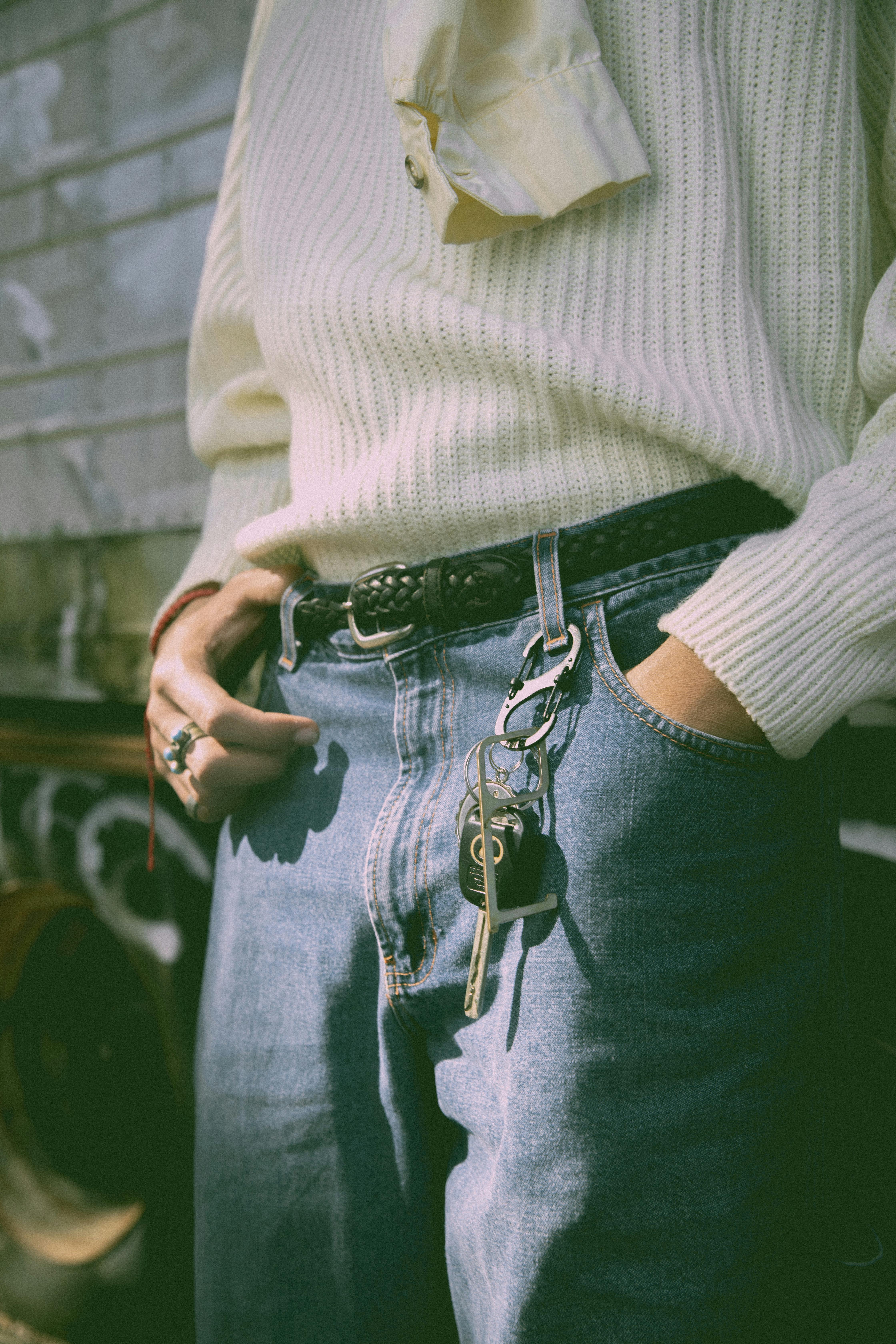 Close-up view of casual jeans and sweater, showcasing relaxed fashion style.