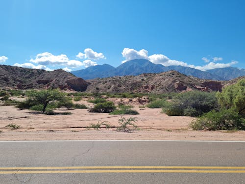 Landscape of Mountains on the Desert seen from an Asphalt Road 