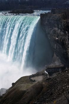Stunning view of Niagara Falls cascading over rocky cliffs, showcasing nature's raw power.
