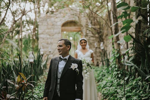 Bride and Groom on the Pavement between Plants 