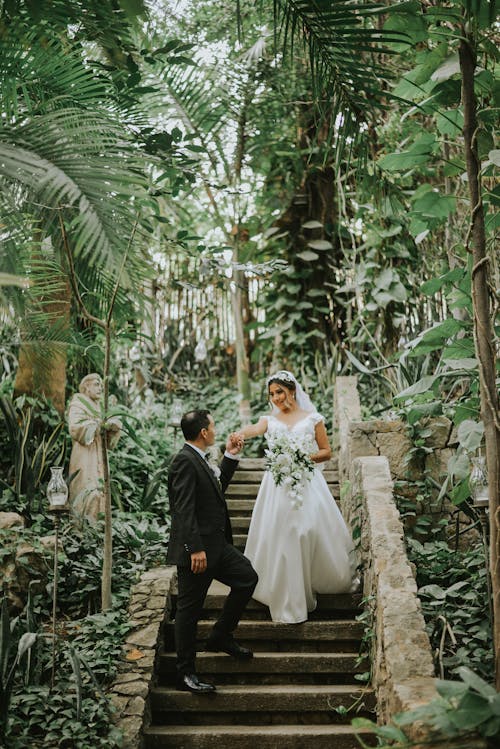 Newlyweds Posing on Stairs in Forest