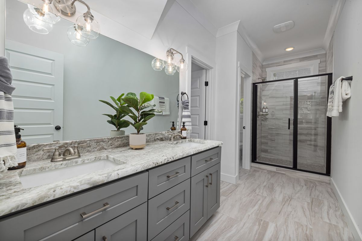 Bathroom renovation reference: modern vanity and a frameless glass shower (stock placeholder)