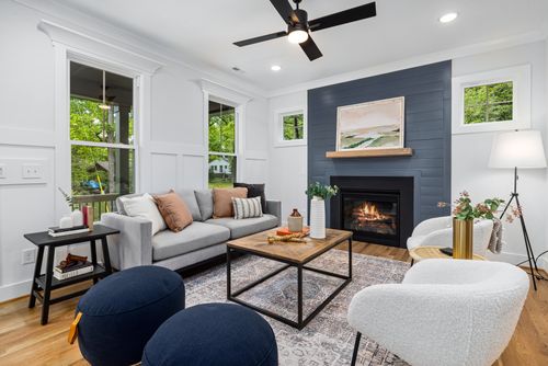 Free Stylish modern living room with a cozy fireplace, elegant decor, and comfortable seating. Stock Photo