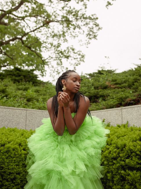 Fashion portrait of a woman in a green dress, captured outdoors in Des Moines.