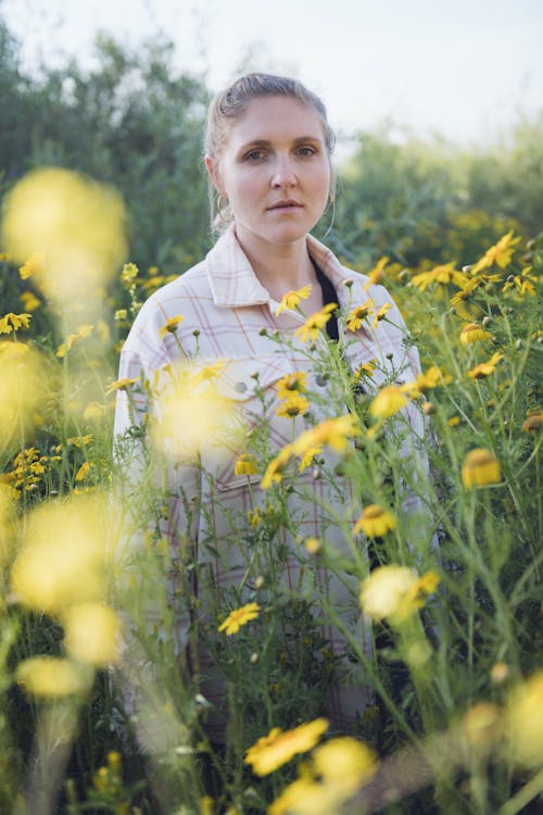 Woman Posing among Flowers on Meadow