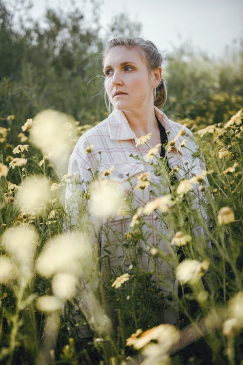 Woman Posing on Meadow Full of Flowers