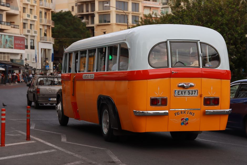 A Malta Public Transport bus on a scenic road in Malta, with a Tallinja card visible