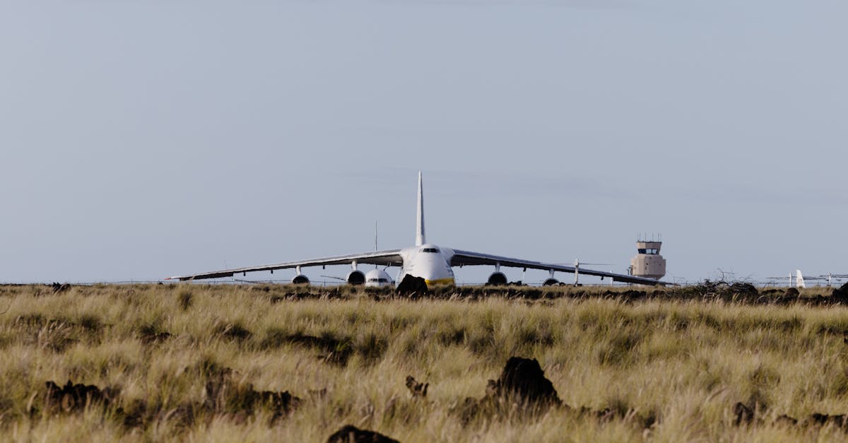 A large aircraft, possibly Antonov, on a runway surrounded by grasslands at Kailua-Kona Airport.