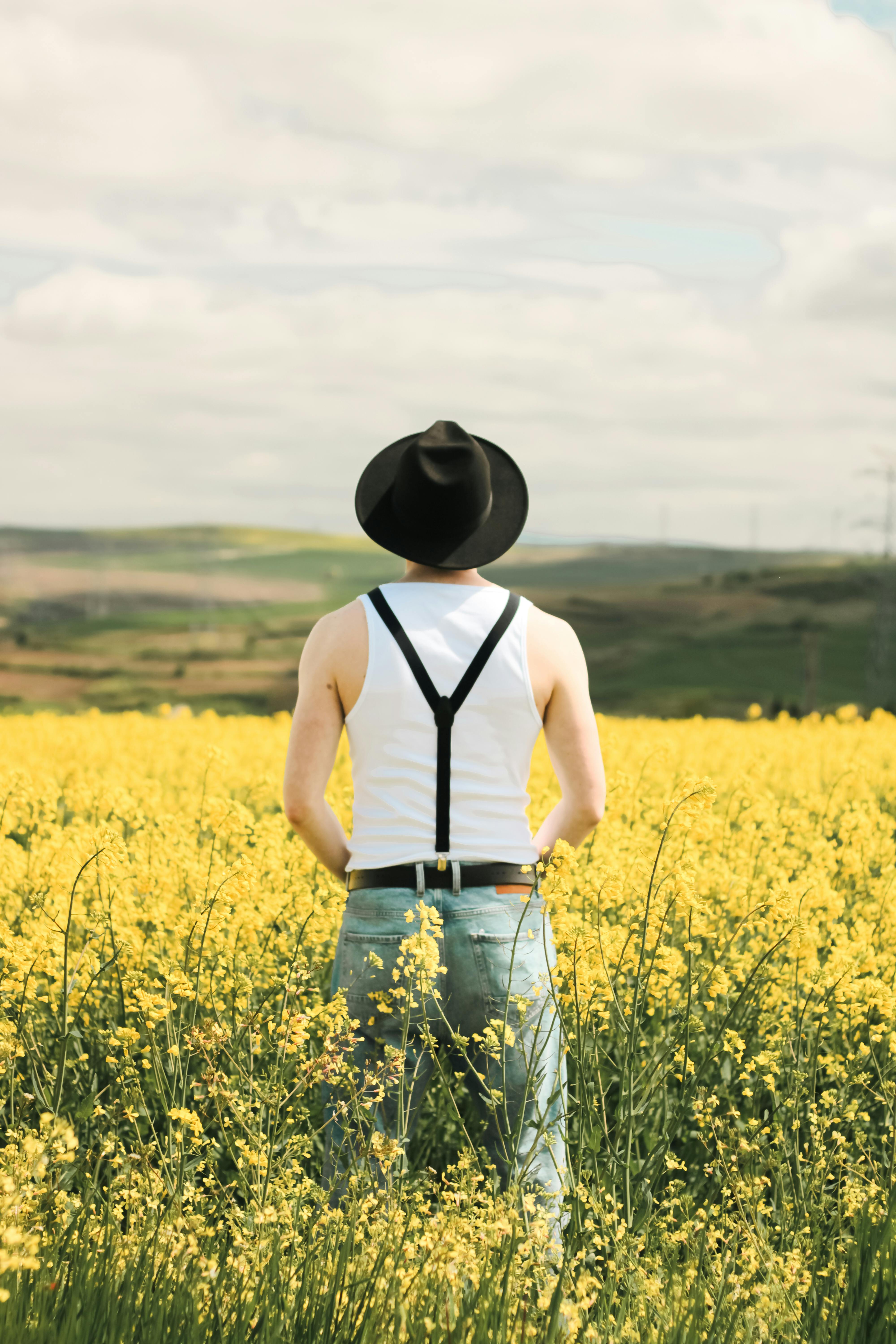 Man Posing in Basketball Tank Top on White Fabric · Free Stock Photo