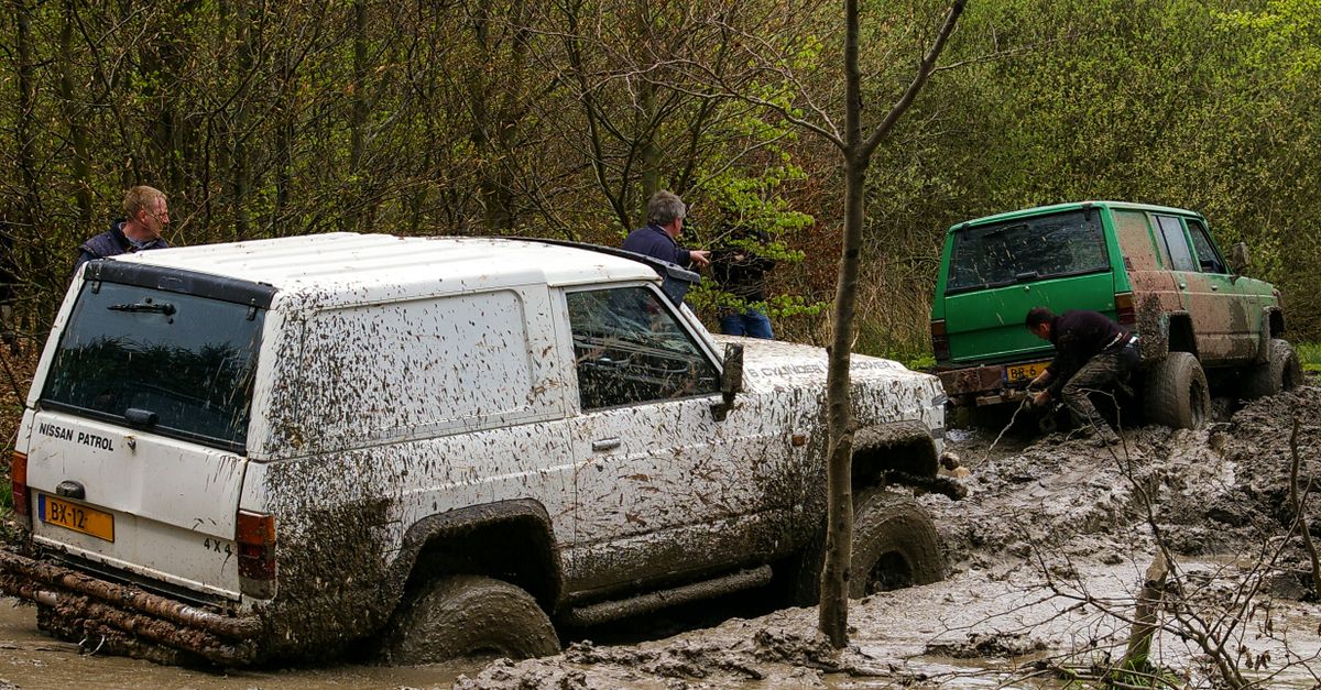 Nissan vehicles engaged in challenging off-road mud adventure in Stadtoldendorf, Germany.