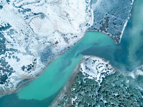 Aerial View of Fields and Forest on Snow-covered Riverbanks