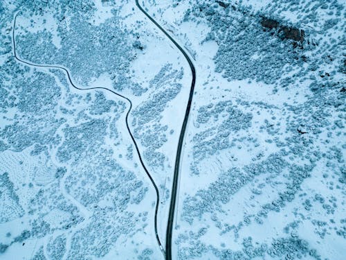 Aerial View of Roads on a Snow-covered Mountainside