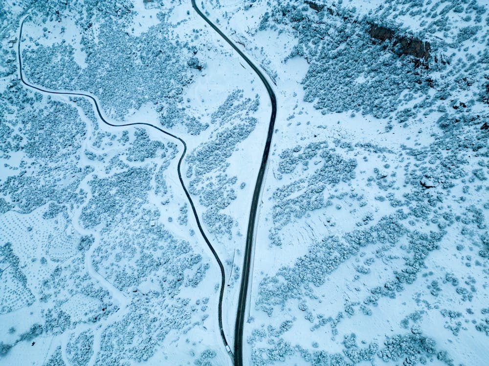 Aerial View of Roads on a Snow-covered Mountainside