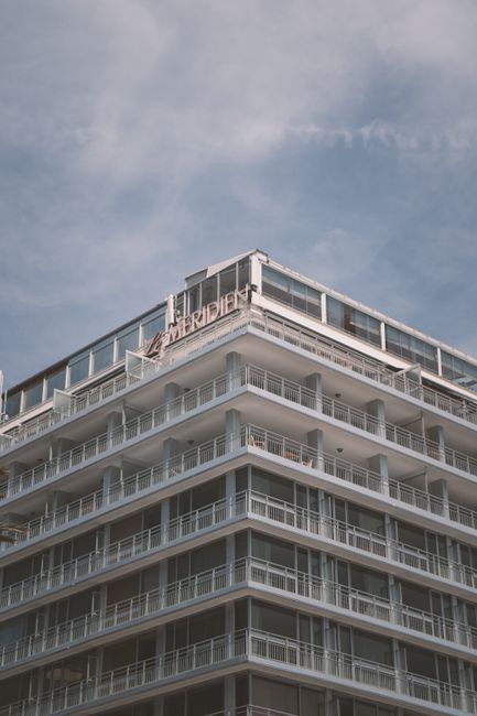 Le Meridien Hotel facade in Nice, showcasing modern architecture and balconies.