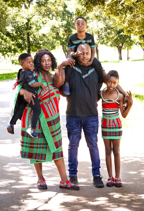 A family poses for a photo in a park