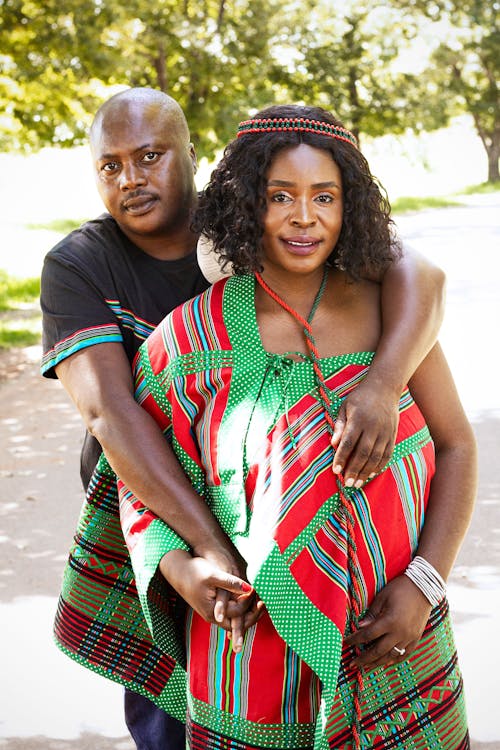 A man and woman in traditional clothing pose for a photo
