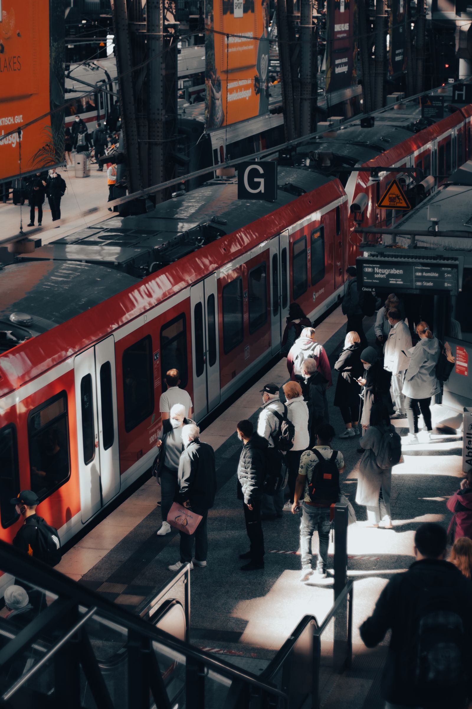 A train platform at a London airport with passengers boarding