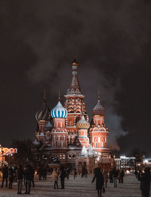 Free A stunning night view of Saint Basil's Cathedral in Moscow with a crowd of visitors. Stock Photo