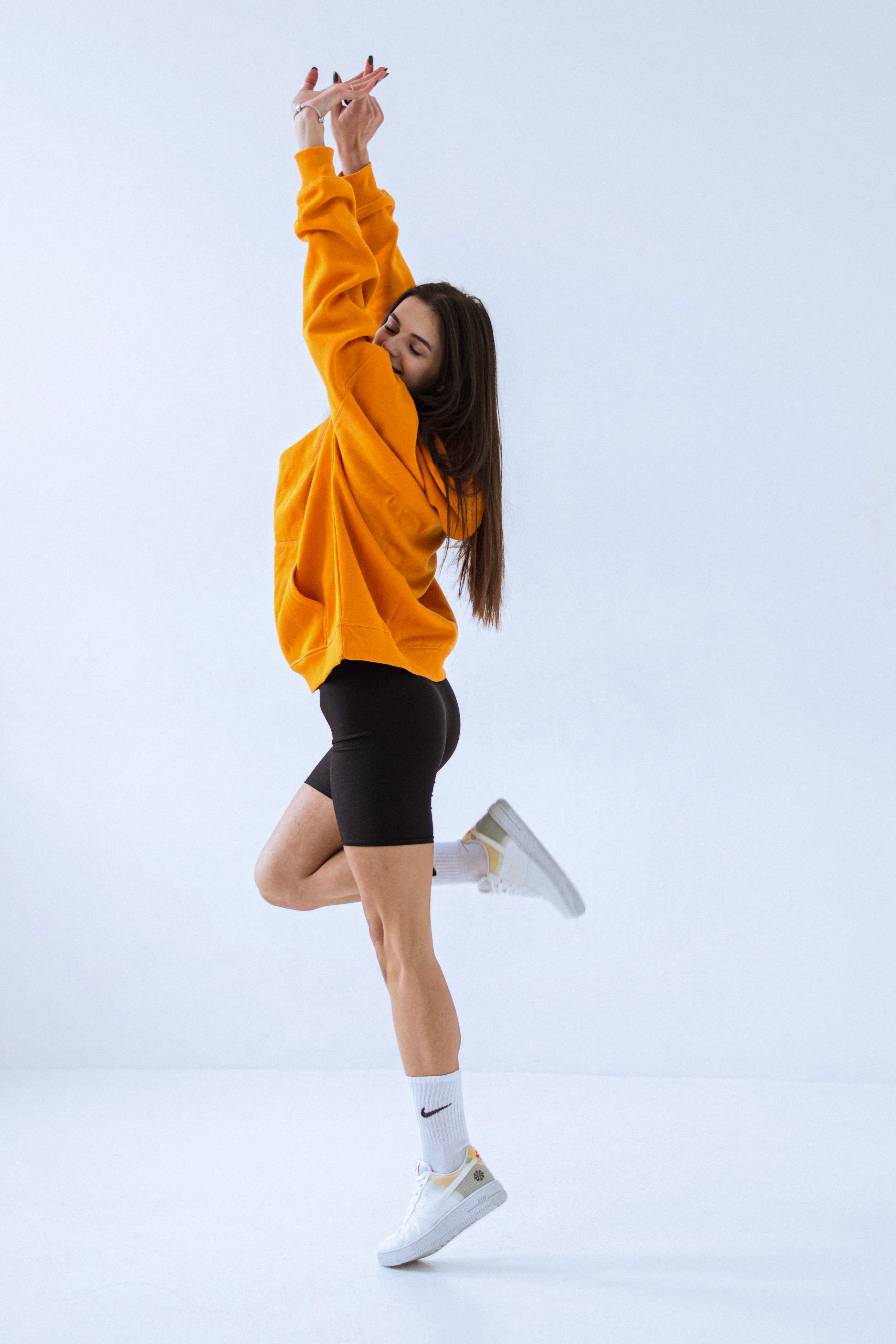 woman wearing oversized hoodie and bike shorts y2k casual