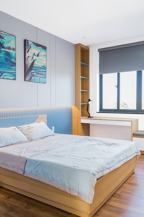 Free Bright, contemporary bedroom interior with wooden accents and urban view. Stock Photo