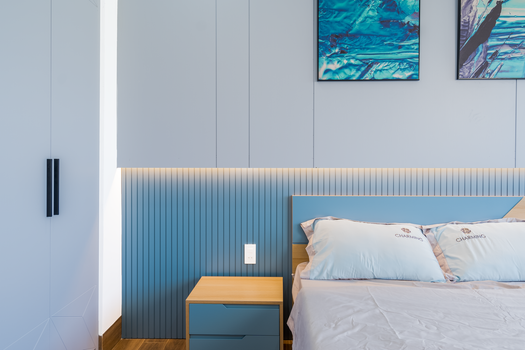 Stylish modern bedroom with blue accents and minimal decor.