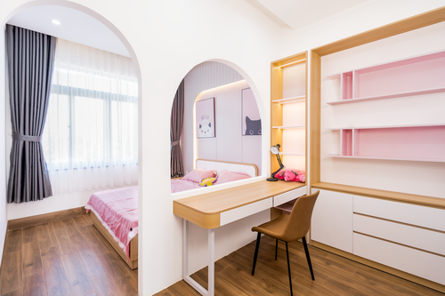 Free Bright, modern bedroom featuring a stylish pink workspace and cozy bed. Stock Photo