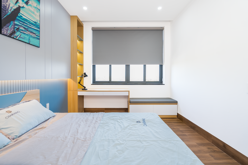Free A contemporary minimalistic bedroom featuring a bed, desk, and modern decor. Stock Photo