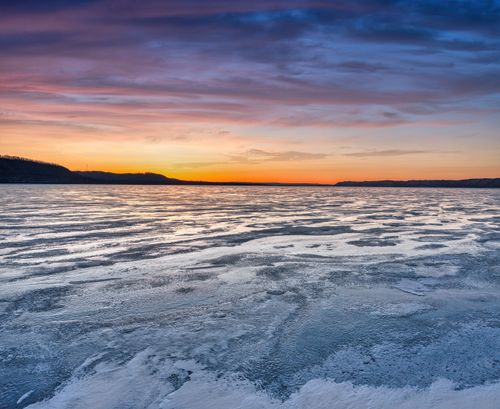 Free Stunning sunset over a frozen lake in Lake City, Minnesota with colorful sky reflections. Stock Photo