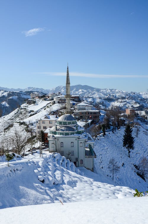 Mosque with Minaret in Snowy Mountains