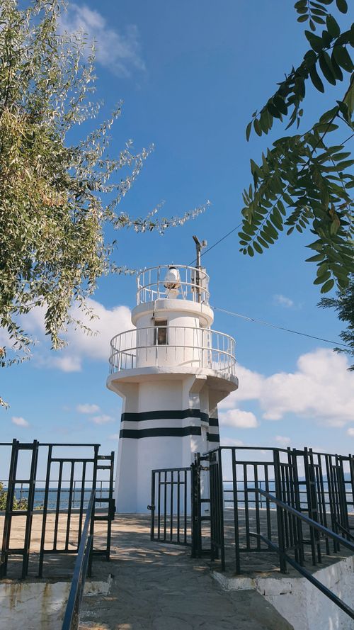 Free White lighthouse near the sea under a clear blue sky in Gerze, Sinop. Captured during summer. Stock Photo