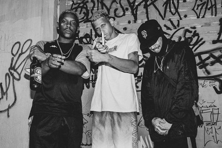 Black And White Photo Of Three Young Man In Baggy Clothing