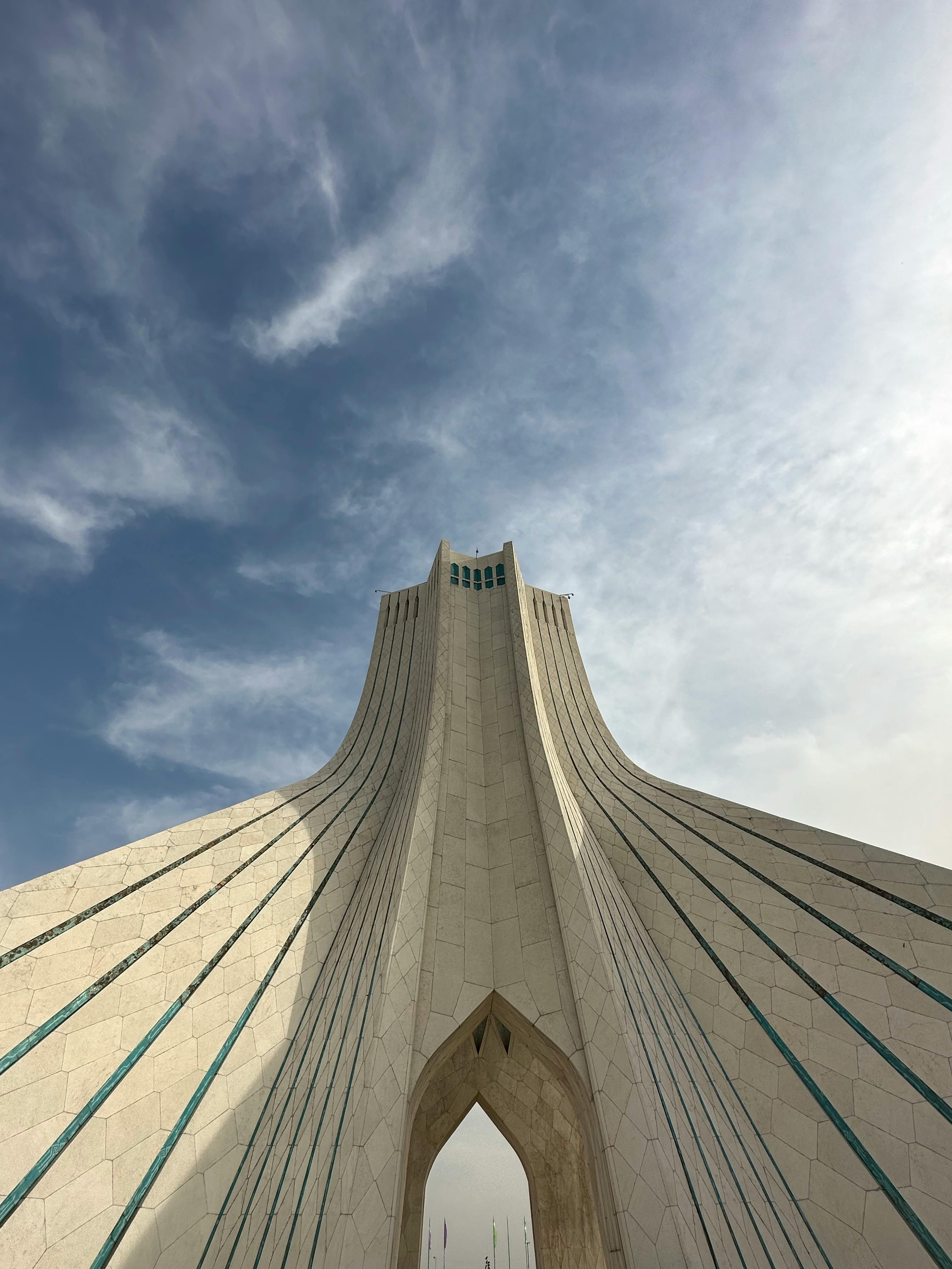 the top of a tall building with a blue sky