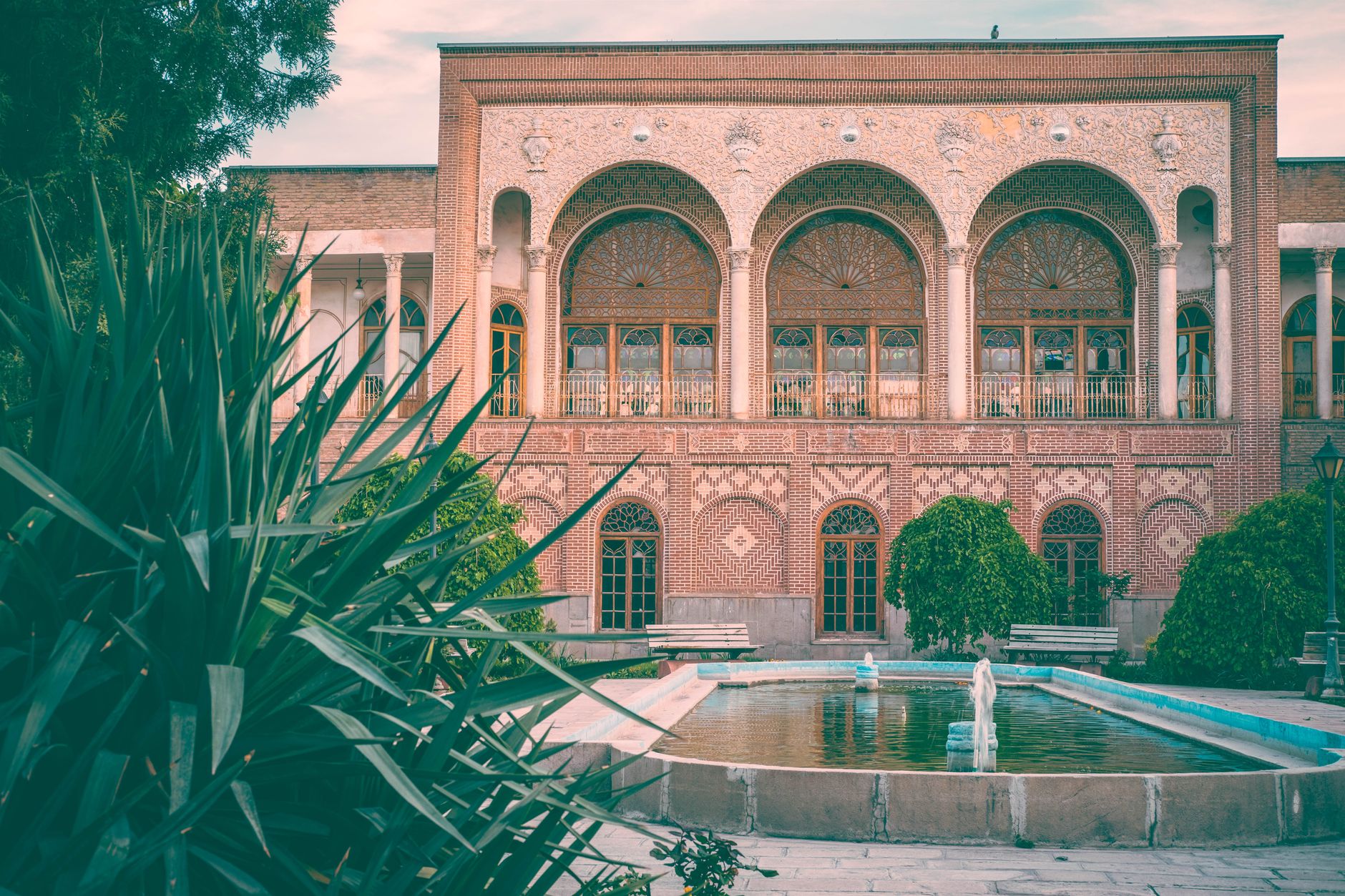 Stunning view of Behnam House, a landmark in Tabriz, Iran, with beautiful gardens and fountain.