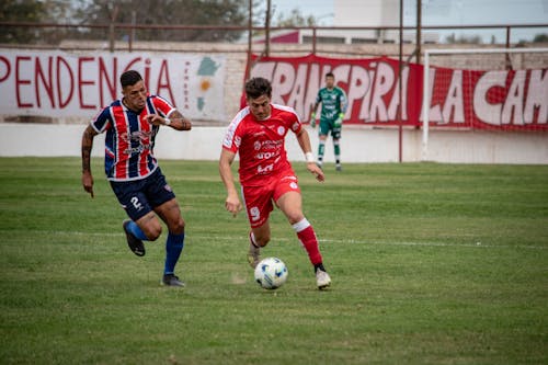 Footballers on Pitch During Match