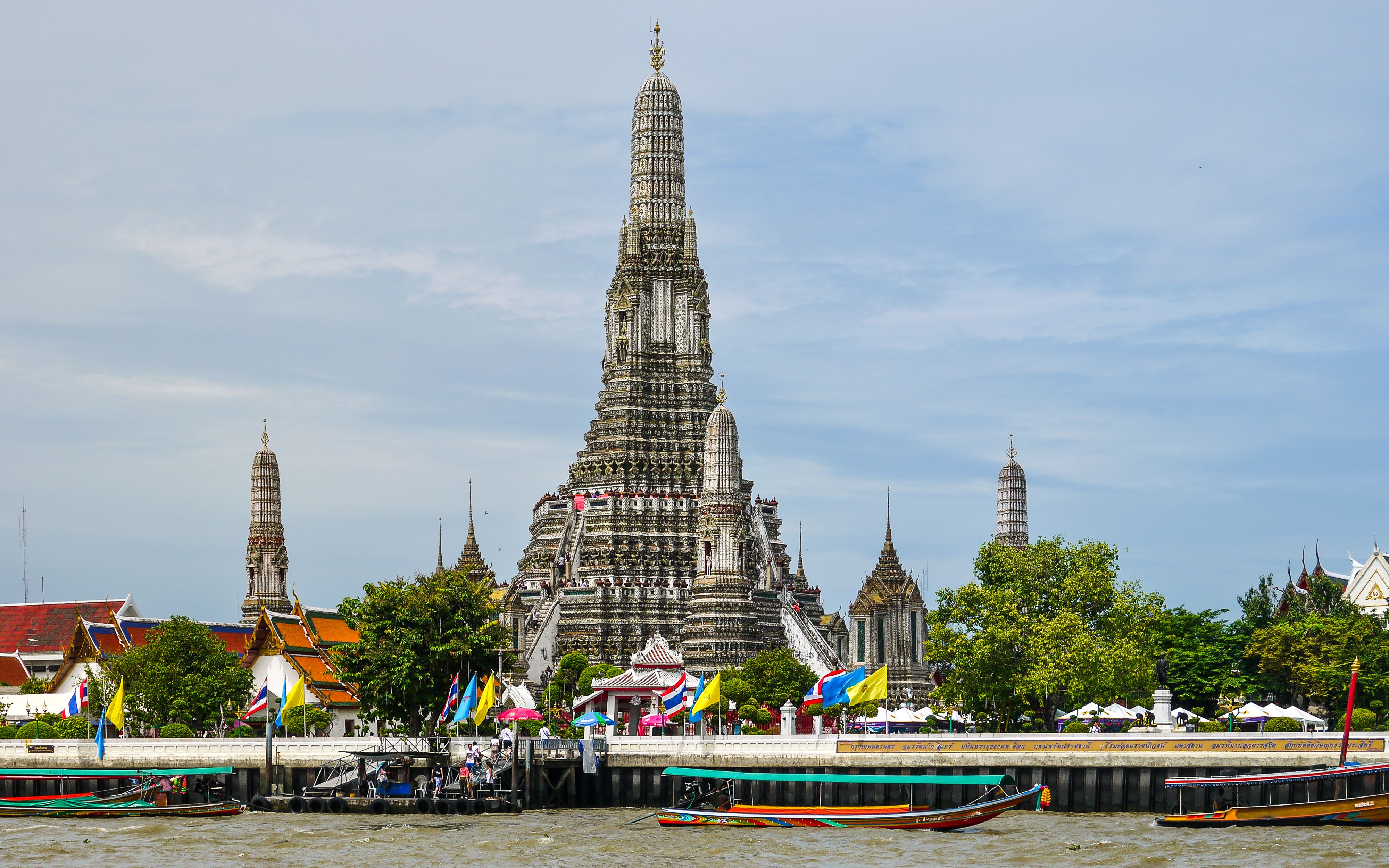 Wat Arun spires seen from across the Chao Phraya river at sunset