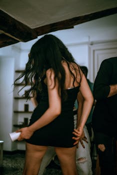 Energetic dance scene at a lively house party in Genoa, Italy.