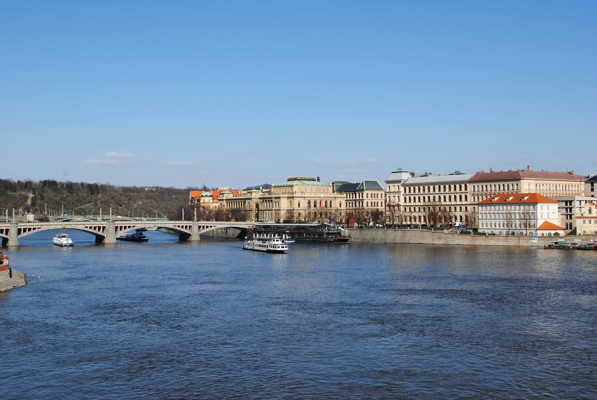 Captivating scene of Vltava River with historic bridge and architecture in Prague, Czech Republic.