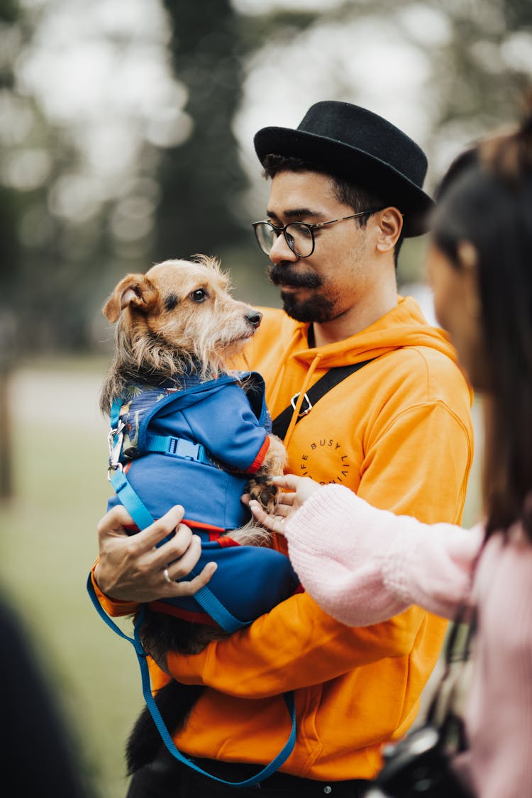 Man Holding His Dog 