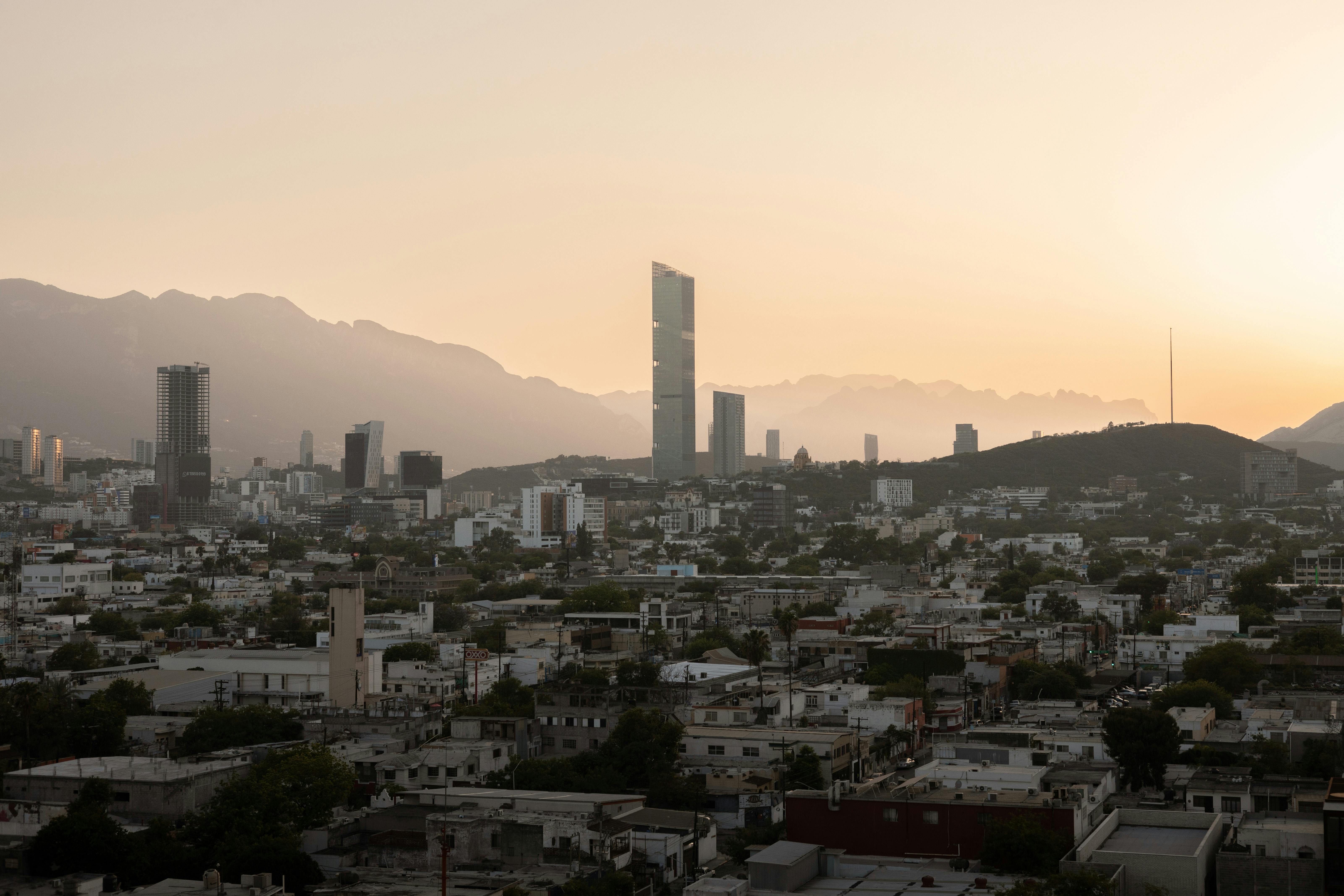 a city skyline with mountains in the background