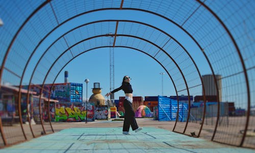 Young Woman on a Treadmill Covered with a Steel Structure