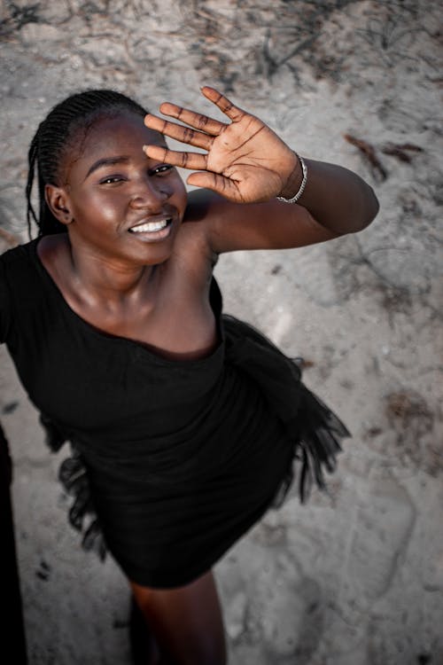 Young Woman Covers Her Eyes Against Strong Light